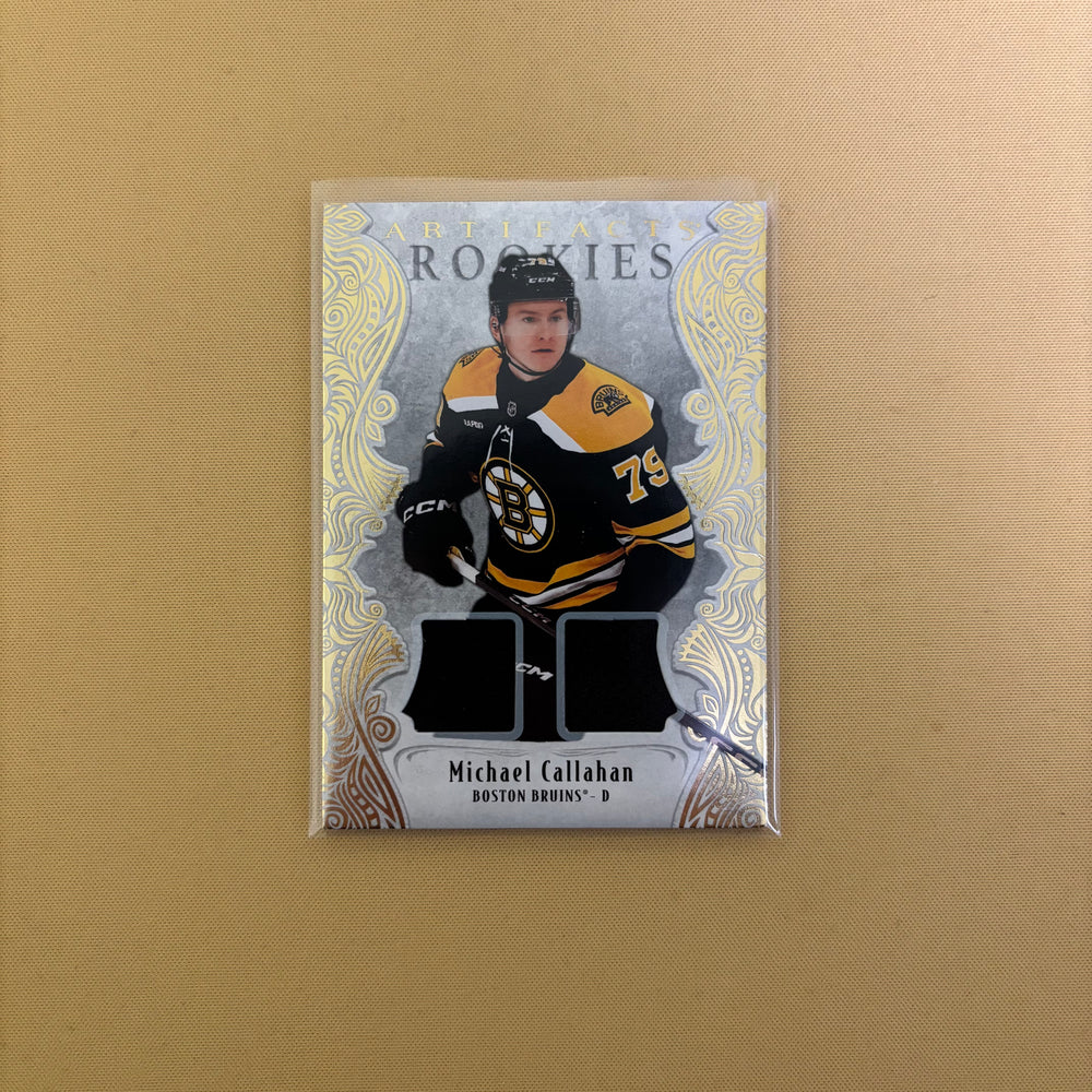 2025-26 Artifacts Bruins Michael Callahan Rookie Gold Material Dual Jersey /499 Sports Card