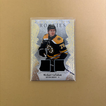 2025-26 Artifacts Bruins Michael Callahan Rookie Gold Material Dual Jersey /499 Sports Card