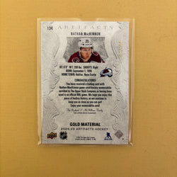 2025/26 Upper Deck Artifacts Gold Material Jersey Nathan MacKinnon /199 Colorado Avalanche #134 Sports Card