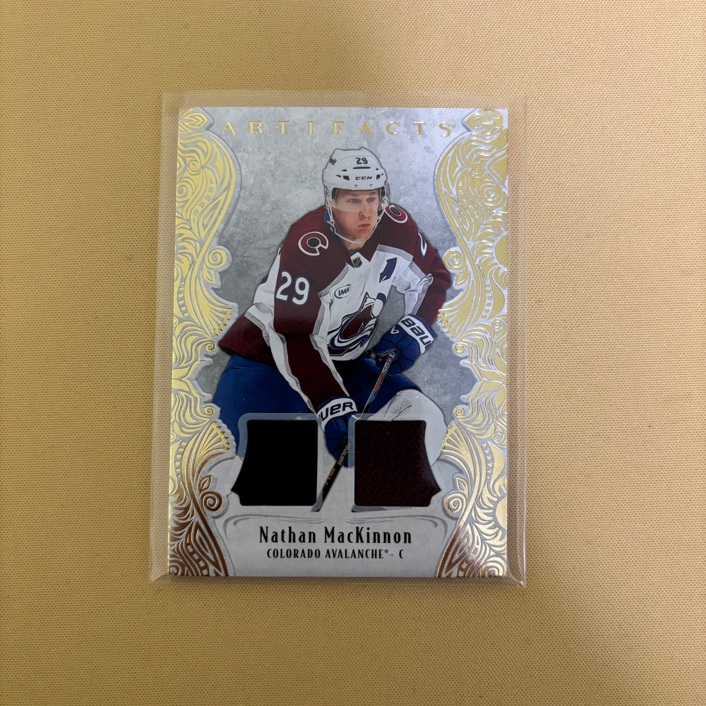 2025/26 Upper Deck Artifacts Gold Material Jersey Nathan MacKinnon /199 Colorado Avalanche #134 Sports Card